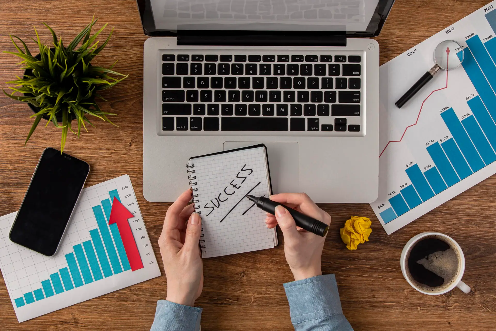 top-view-office-desk-with-laptop-growth-chart